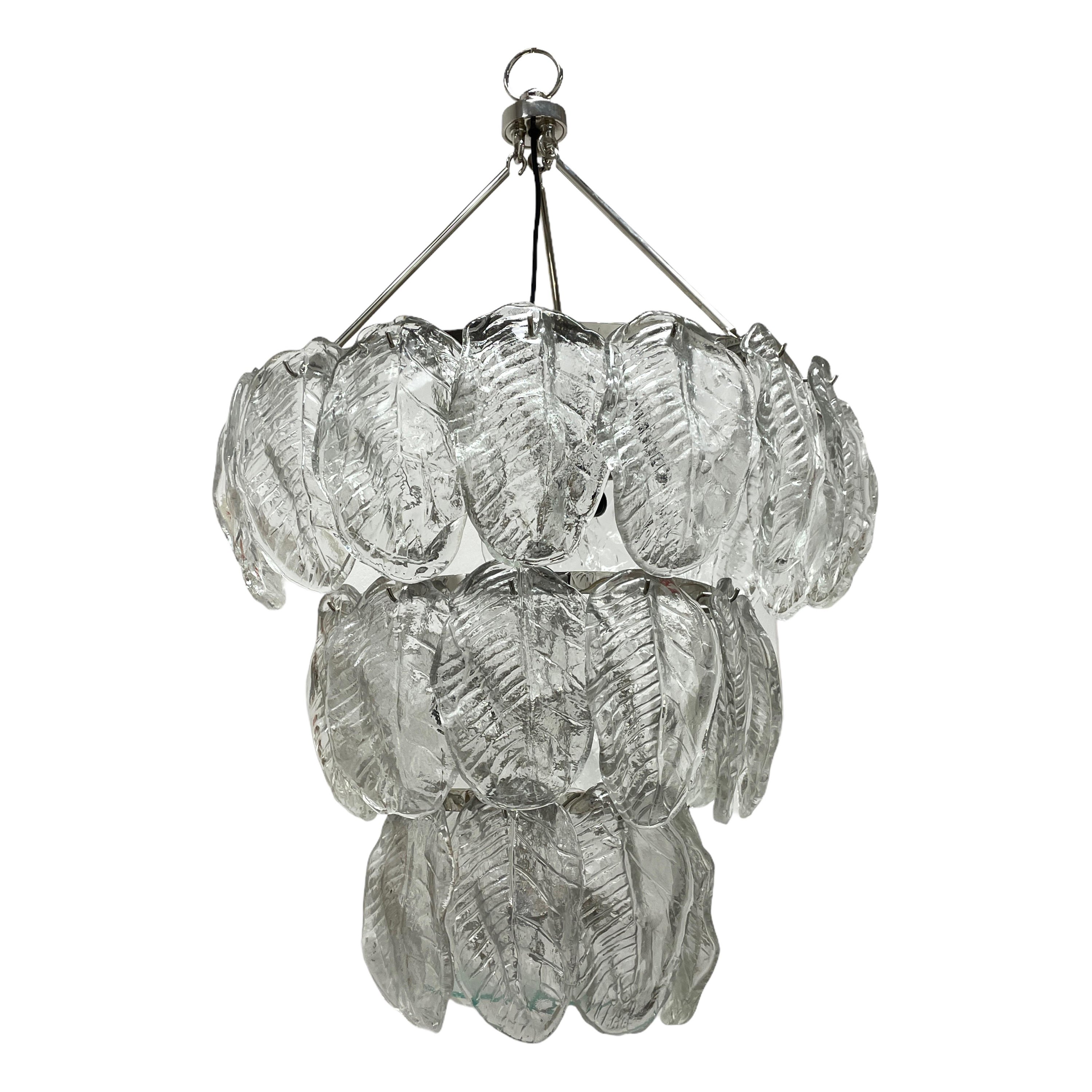 This exquisite large chandelier attributed to the legendary atelier of Venini in Italy, circa 1980s. It features a lot of leaf motif hand blown thick and heavy Murano glass shades. The glass shades hang on a chrome frame. With its clean modernist