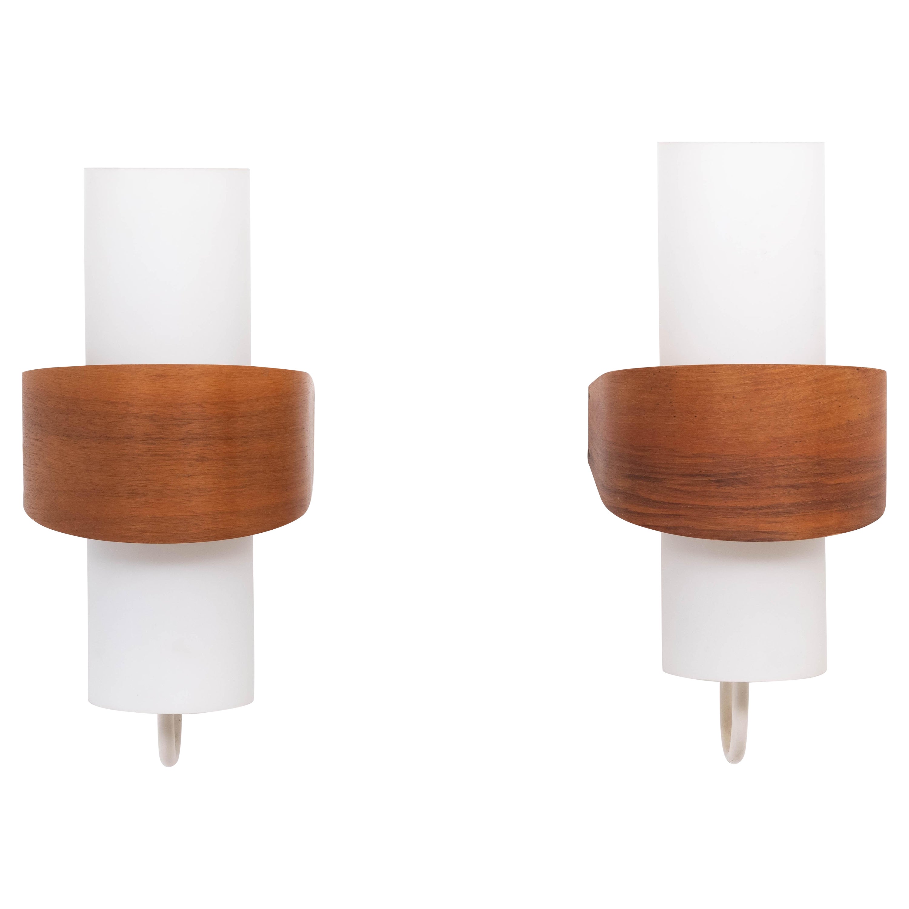 Love these wonderful wall lights. Design Louis Kalff Produced by Philips Holland 1960s Model NX40
Satin finish Glass tubes, surrounded by a Teak Plywood shade, on a metal armature.
Gives a very nice warm light when lid. Good size. and good