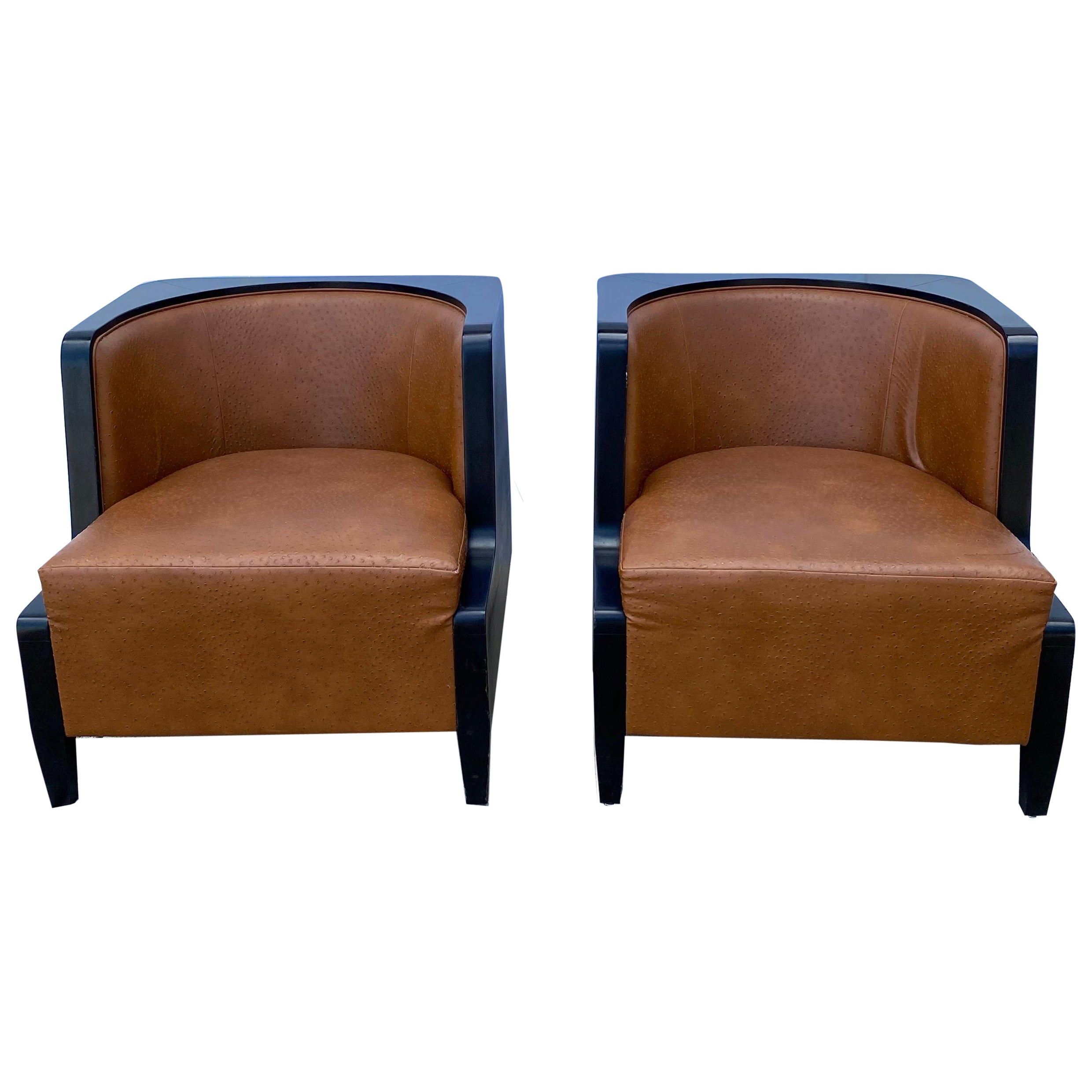 Pair of Art Deco style lounge chairs in black lacquer and cognac leather with ostrich markings. Manufactured by Rosello Paris, producers of art deco styled furniture since 1928.