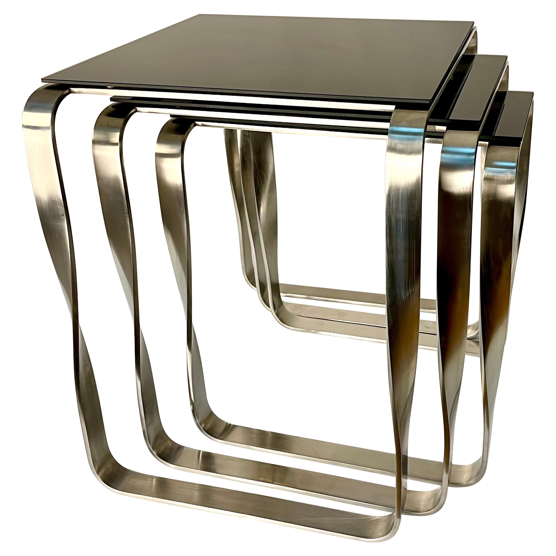 Modern style wanderlust side nested table. Aged silver and Black Glass
Serene pieces where exclusivity and precision are shown in small details such as the hand-turned metal and cold bending.

The robustness of the metallic structures is combined