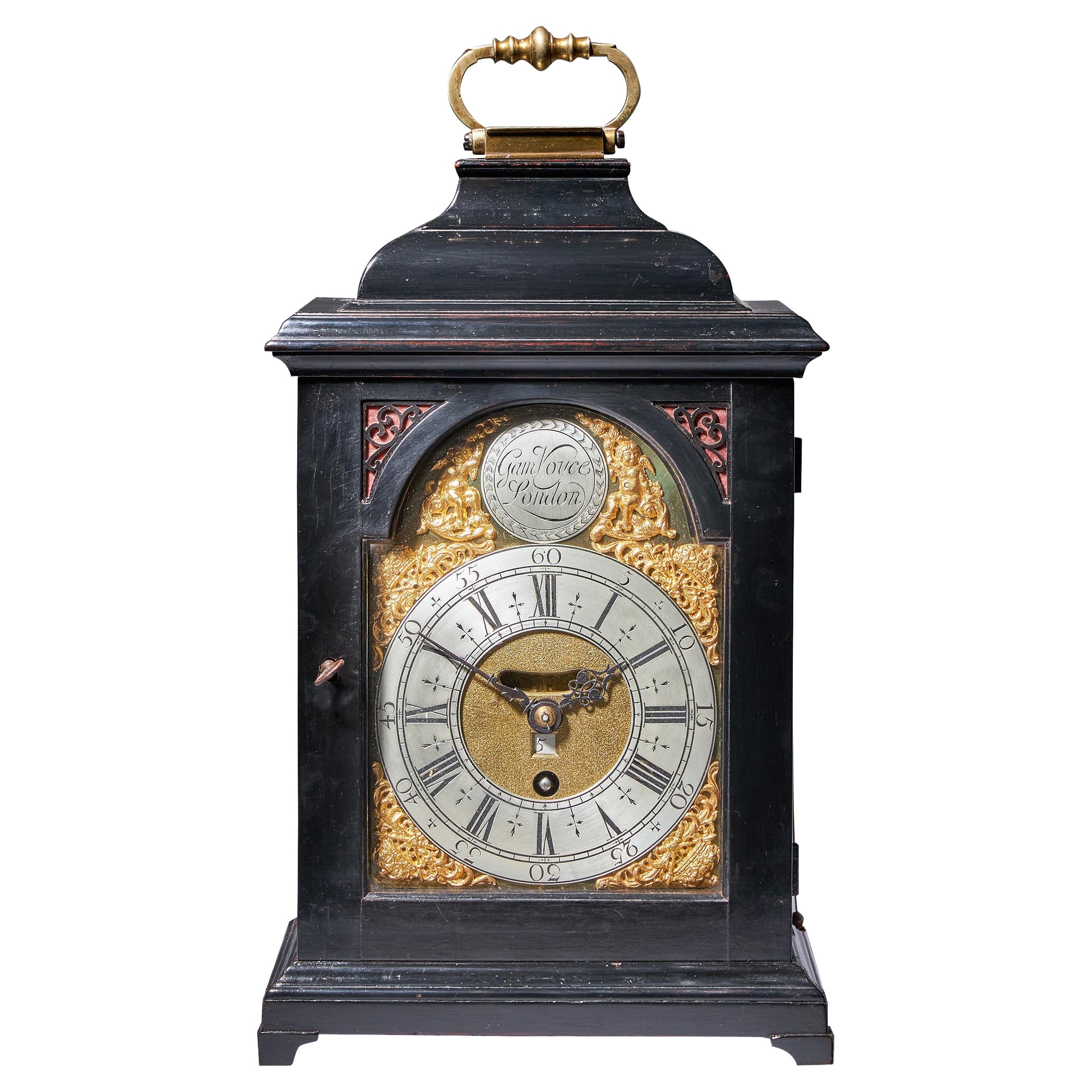 An extremely attractive early 18th century George I period table clock of small proportions by Gamaliel Voyce, c.1725.

The proportions of the petite clock (measuring only 14 inches (36cm) with the handle up) are such that is difficult not to fall