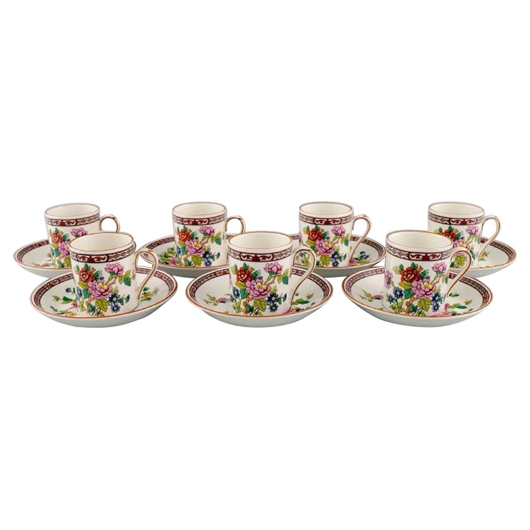 Coalport, England. Seven Flower of Tibet chocolate cups with saucers.