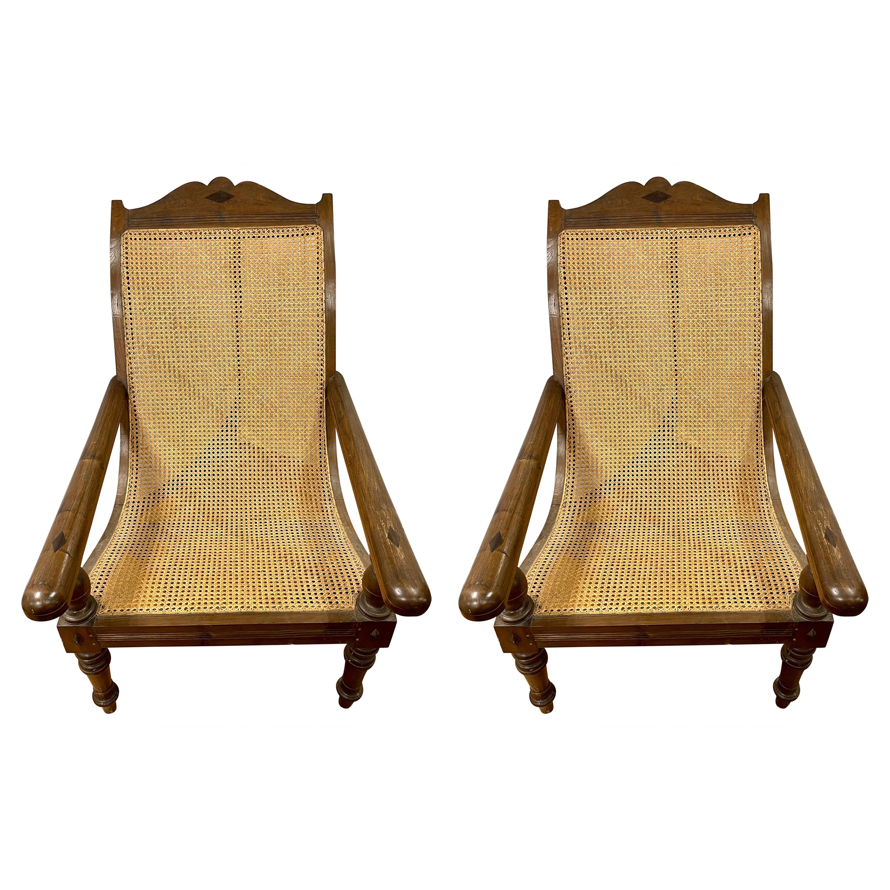 Pair of Matching British Colonial Cane Plantation Chairs with Pullout Leg Rests