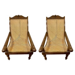 Antique Pair of Matching British Colonial Cane Plantation Chairs with Pullout Leg Rests