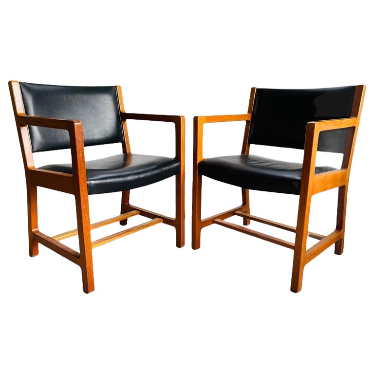 Attractive set of 6 leather dining armchairs with solid two tone wood. These chairs are very well built and are solid. They have beautiful simple lines and will make a great addition to any mid-century modern table. The chairs are in good vintage