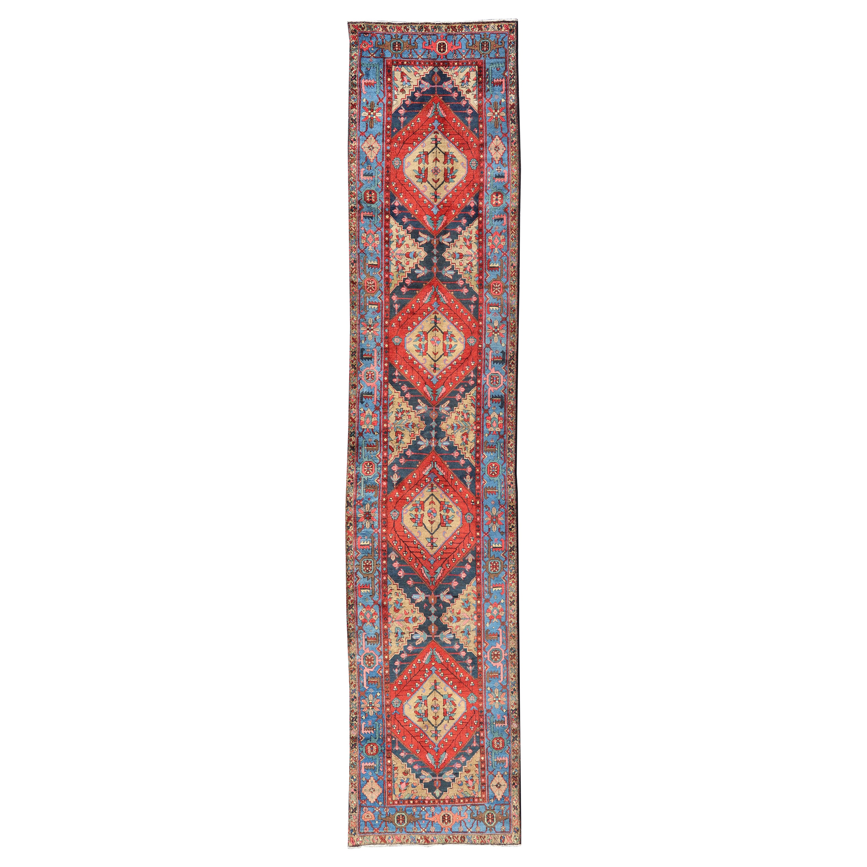 Antique Geometric Persian Long Heriz Runner in Red, Blue, Yellow, and Tan For Sale