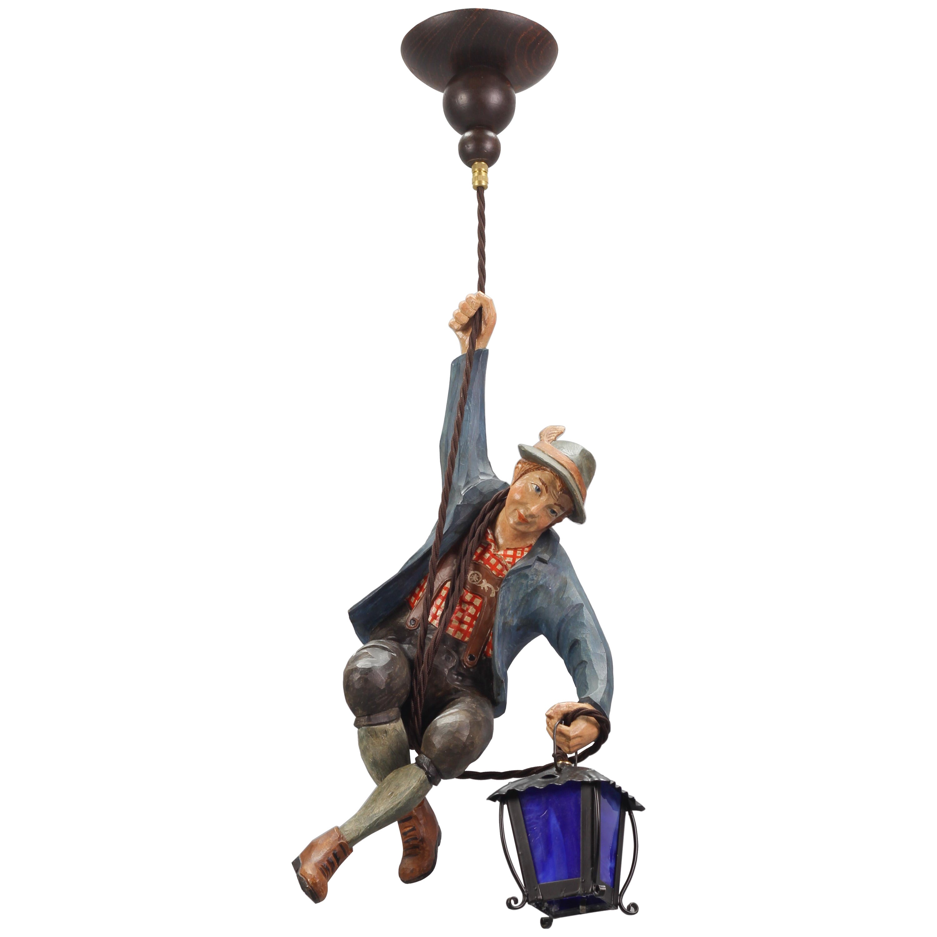 Pendant Light with Figure of a Mountain Climber and a Blue Glass Lantern For Sale