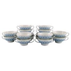 Bjørn Wiinblad for Rosenthal, Twelve Lotus Porcelain Bouillon Cups with Saucers