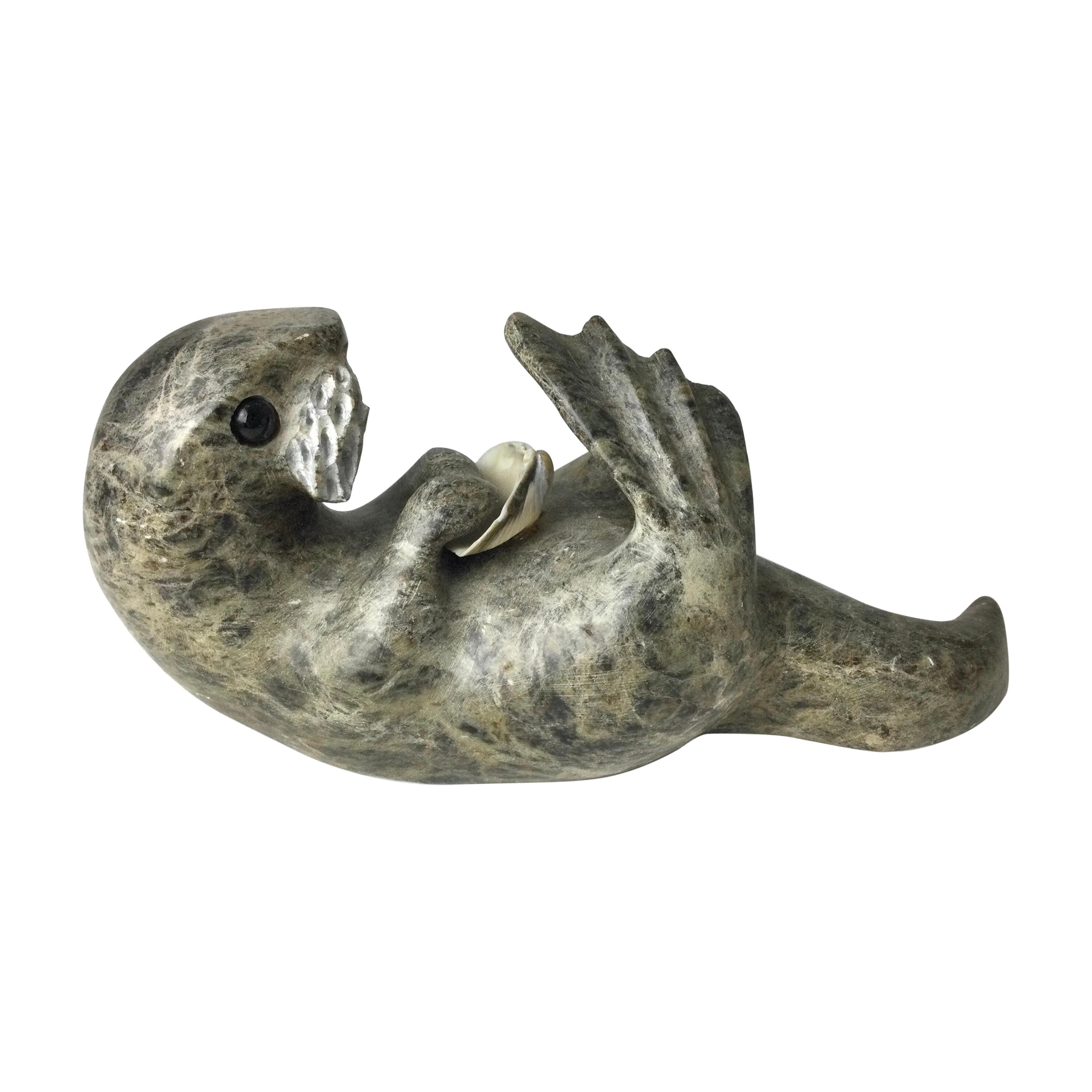 Inuit Stone Carving of a Otter with Shell Signed Drake For Sale