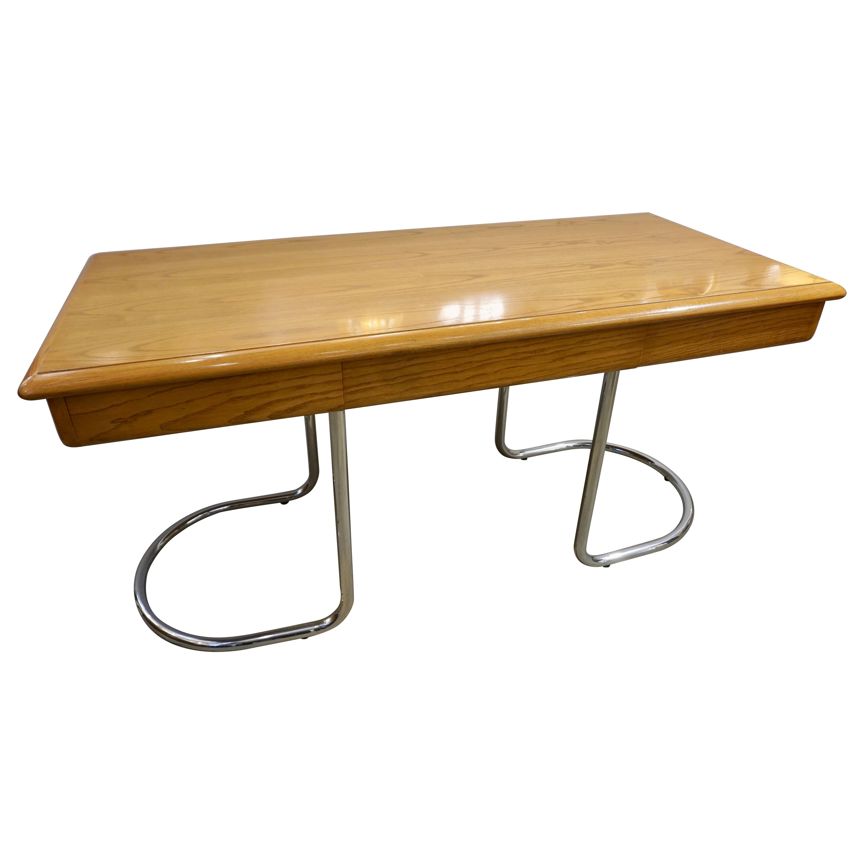A Mid-Century Modern center desk in ash tree of clean sleek shape, very well designed, the top surface with quality rounded corners and minimum thickness to allow 3 functional drawers, raised on continuous curved legs in nickel finish with a very