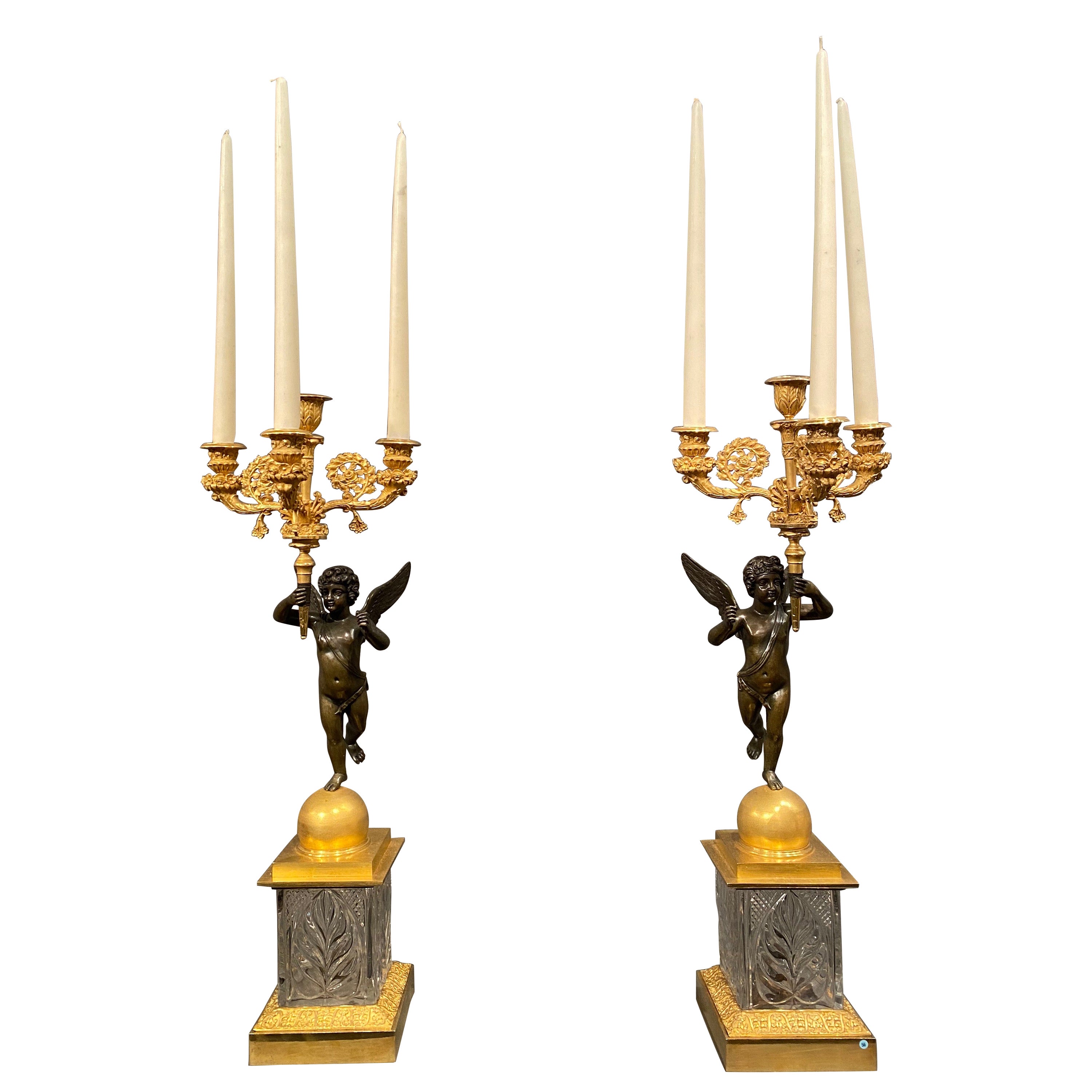 These pair of candelabra are very unusual with the cut crystal bases. Glass was one of the most expensive materials in these times and therefore exclusive. The usual way you see these type of candelabra is with a gilt or patinated bronze base. The