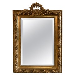 French Giltwood Mirror, 19th Century, with a Floral Wreath Form Crest and Spray
