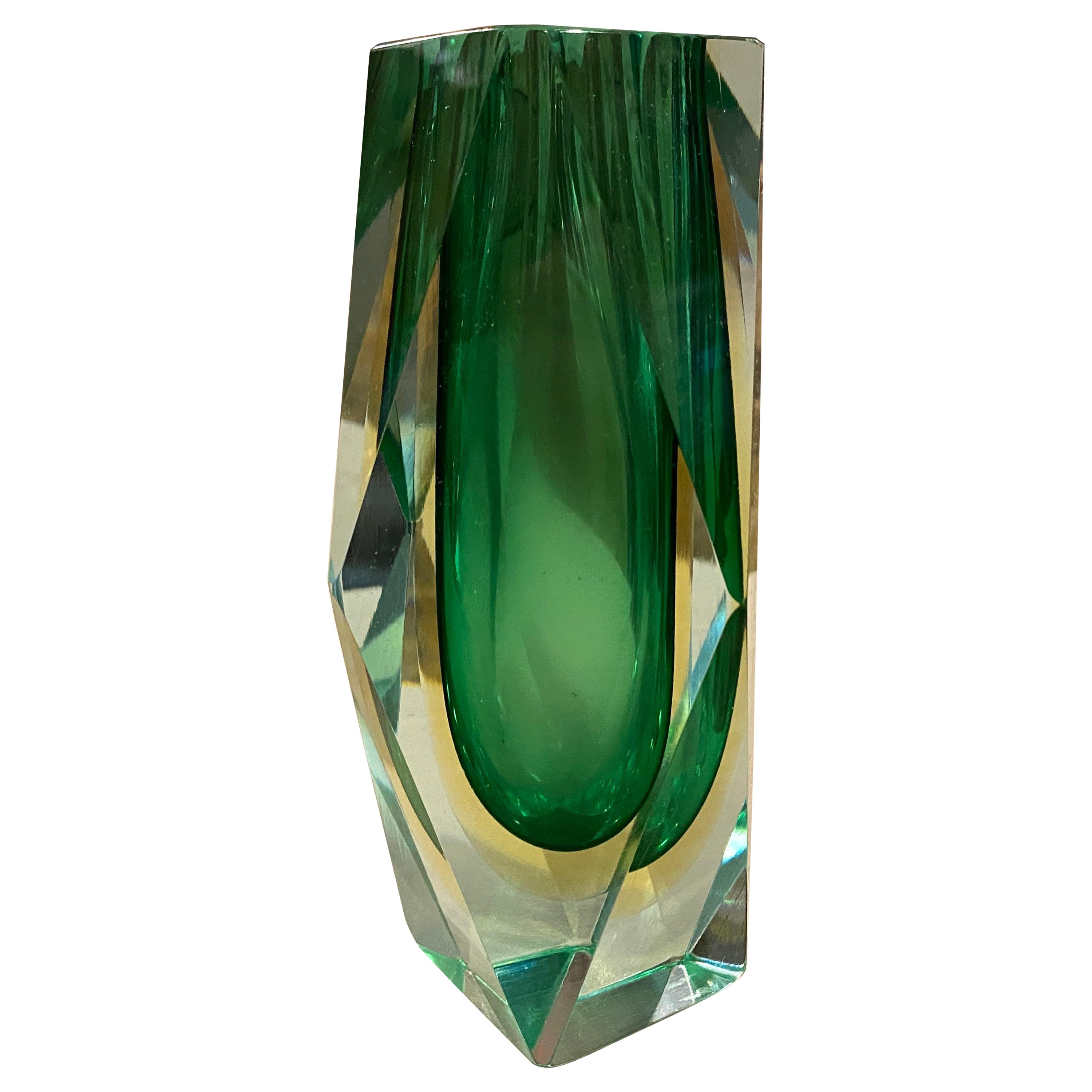 A green and yellow Sommerso Murano glass vase designed and manufactured in Italy in the Seventies, the multifaceted style was very popular in Murano in that period, is a stunning example of Italian craftsmanship and design from that era. The vase