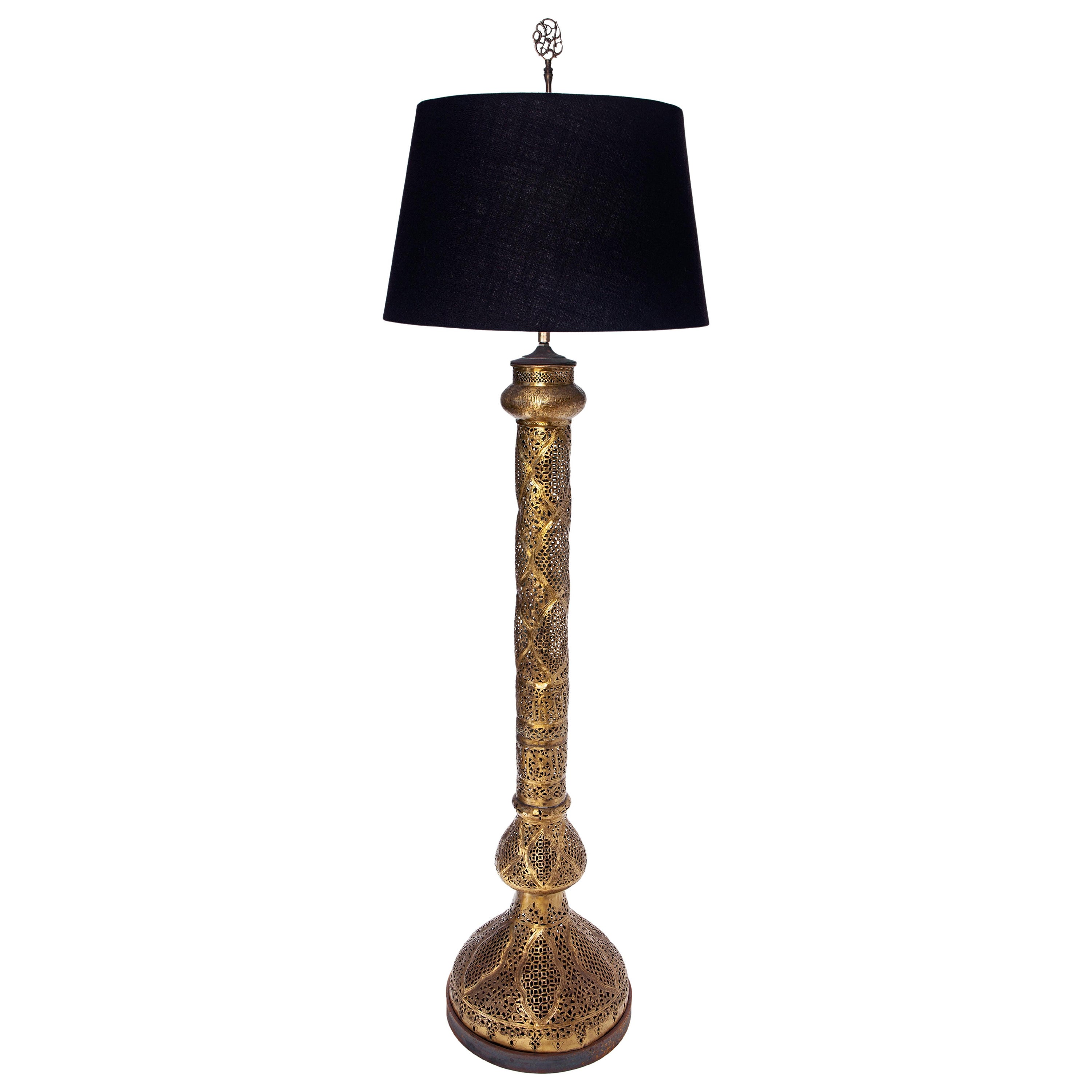 Opulent 20th century Moroccan, Moorish style pierced brass & iron floor lamp.
Handmade with individual patterned panels of pierced foliate & openwork design. 
Rising from wide trumpet base to a tapering cylinder with decorative collars & flared rim.