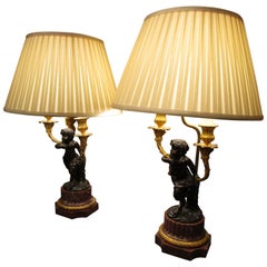 Fine Pair of French Patinated Bronze and Gilt Bronze Cherub Candelabra Lamps