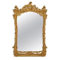 Miroir italien du milieu du 19ème siècle en bois doré roccoco
