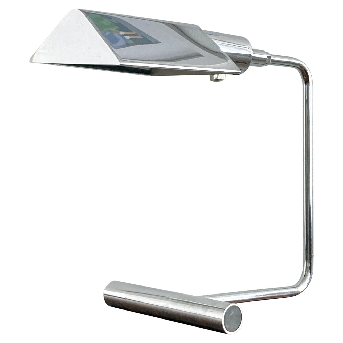 Stunning desk lamp/ reading lamp by Koch & Lowy, signed OMI. Features a pivoting chrome shade with dimmer knob. In good working condition.

The voltage is 110, standard US plug. The lamp has been rewired since the 1960's, it has an Edison socket and
