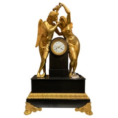 Monumental Marble and Bronze Dore’ Clock Adorned with Psyche and Amor Figures