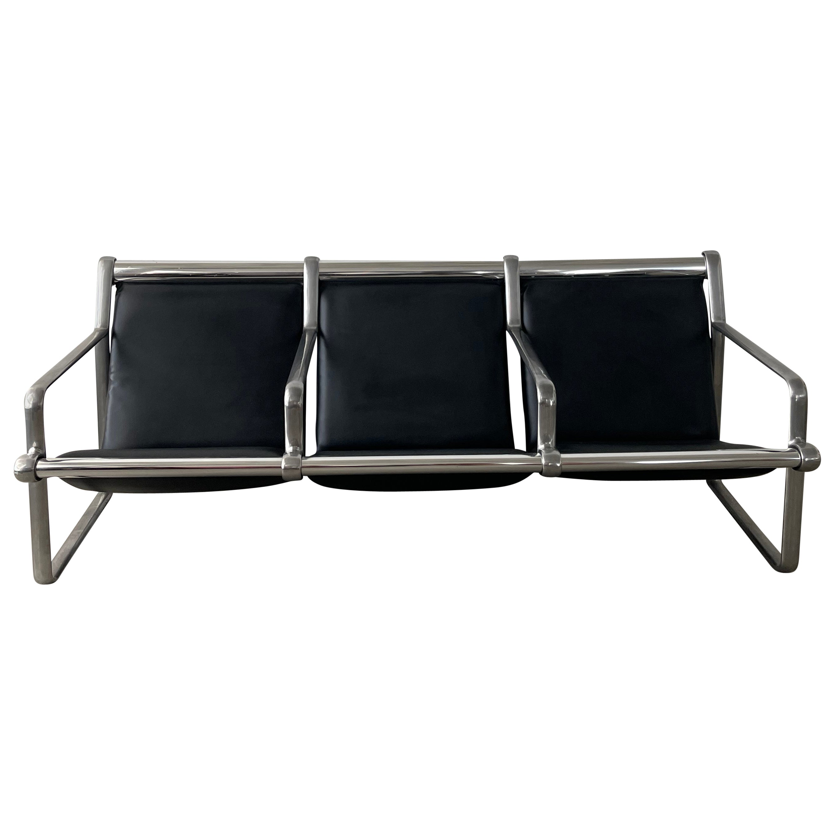 20th century Knoll 3-seat sling sofa by Bruce Hannah & Andrew Morrison was a Mid-century icon. The frame is cast aluminum and the seats are done with a black durable vinyl that replicates leather extremely well. Amazing design that brings character