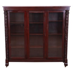 Antique Empire Carved Mahogany Glass Front Triple Bookcase, circa 1900