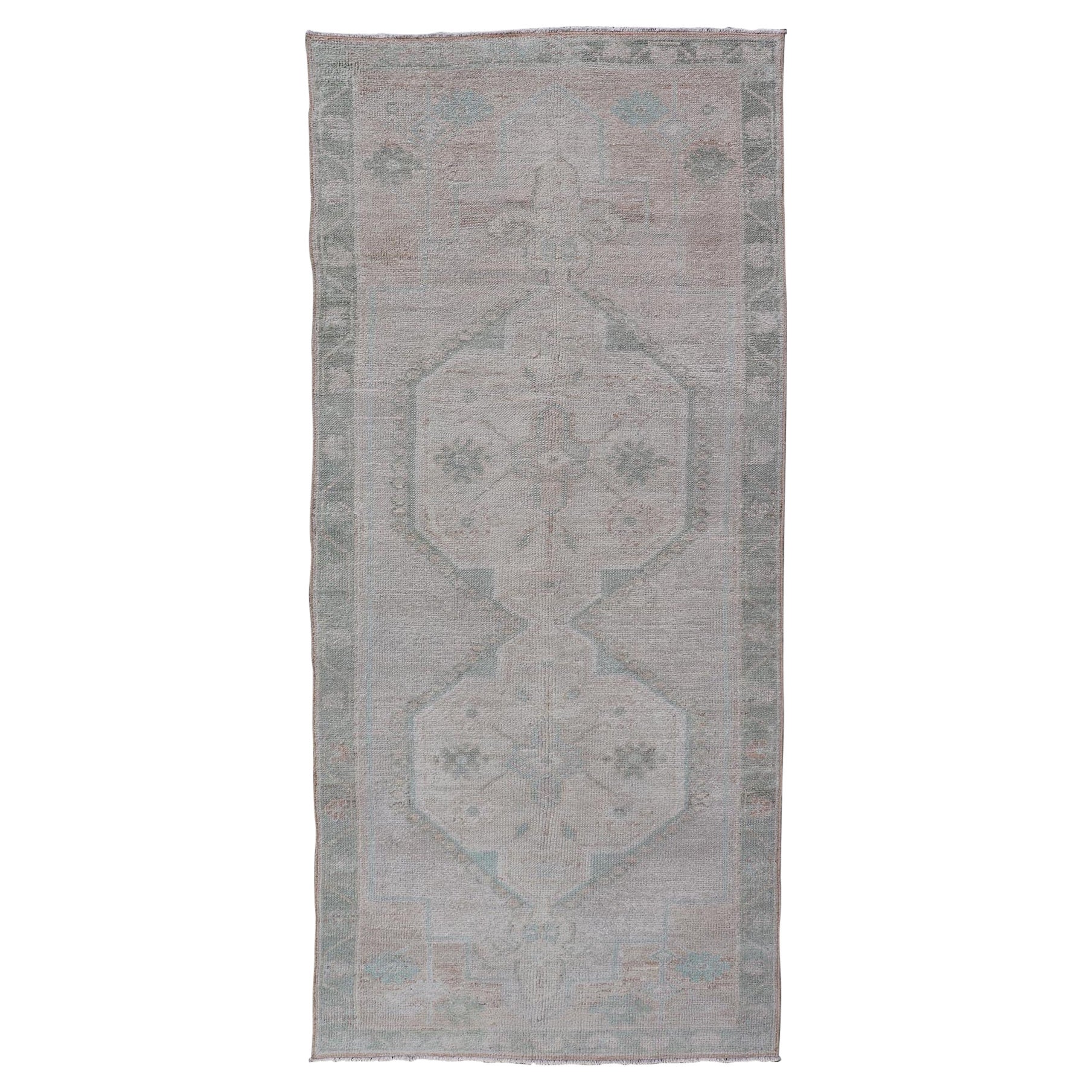 Vintage Turkish Oushak Runner with Subdued Geometric Medallions in Light Tones For Sale