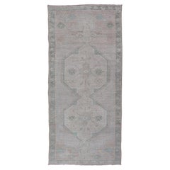 Vintage Turkish Oushak Runner with Subdued Geometric Medallions in Light Tones