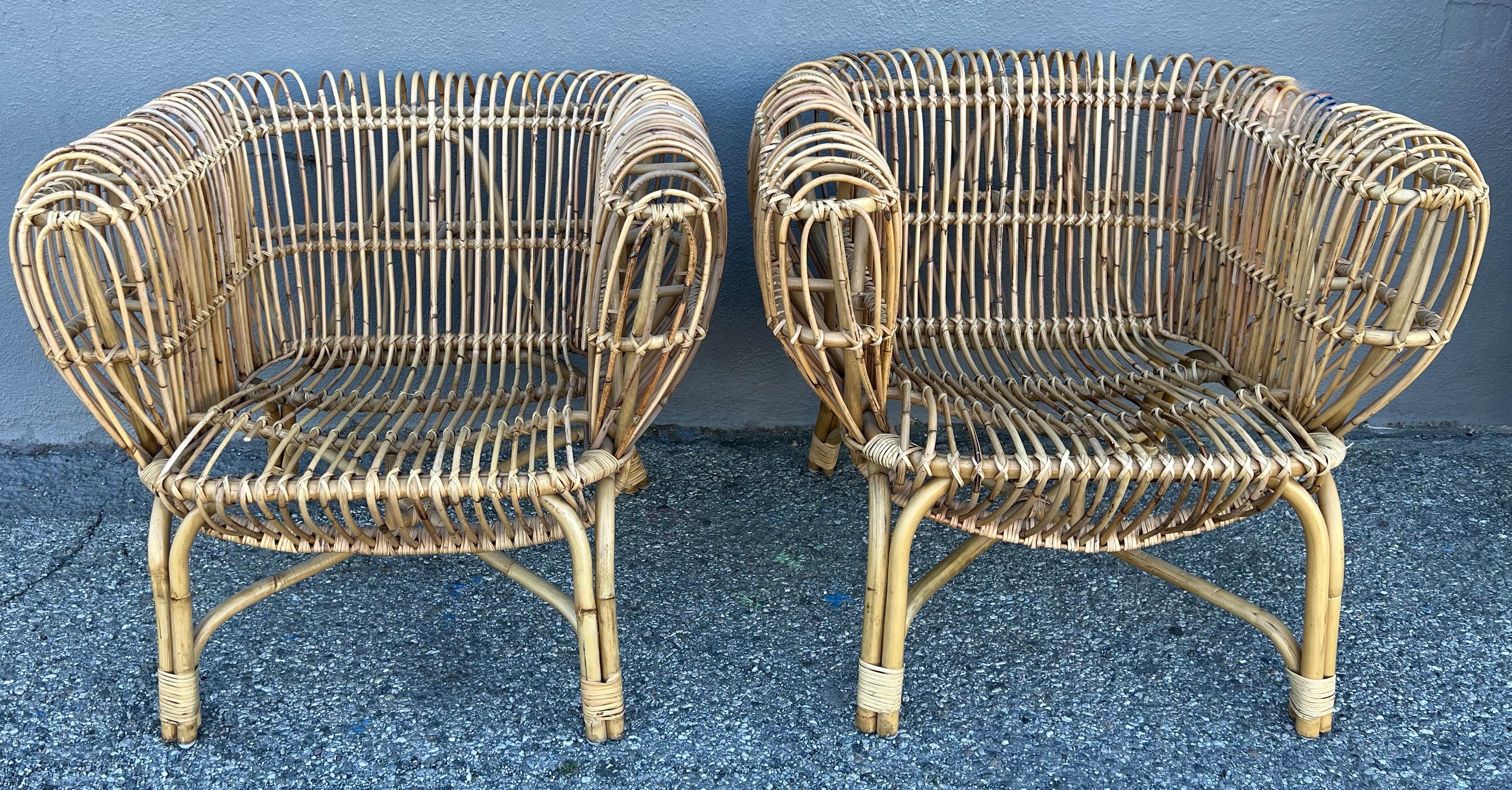 Beautiful pair of pencil rattan chairs in the style of Franco Albini. The perfect compliment many spaces - a lanai, covered patio, poolside or in the den as a classic focal point.  a wonderful addition to a lovely garden or peaceful gathering space.