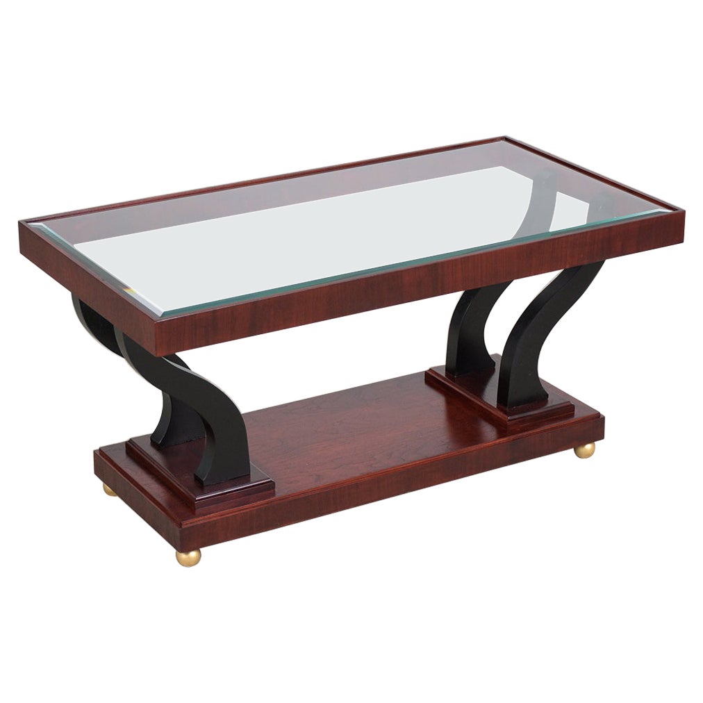 This extraordinary vintage mid-century modern two-tier coffee table is in great condition hand-crafted out of walnut wood and has been completely restored by our expert craftsmen team. This fabulous piece features rich mahogany & ebonized color