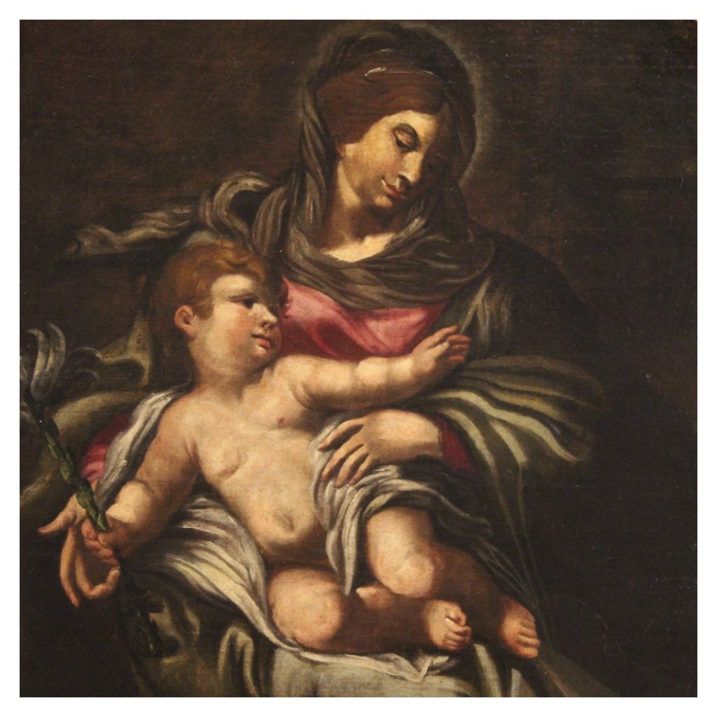 Great Italian painting from the second half of the 17th century. Work oil on canvas depicting a religious subject Madonna with child of good pictorial quality. Painting with a particular elongated oval shape, for antique dealers, interior decorators