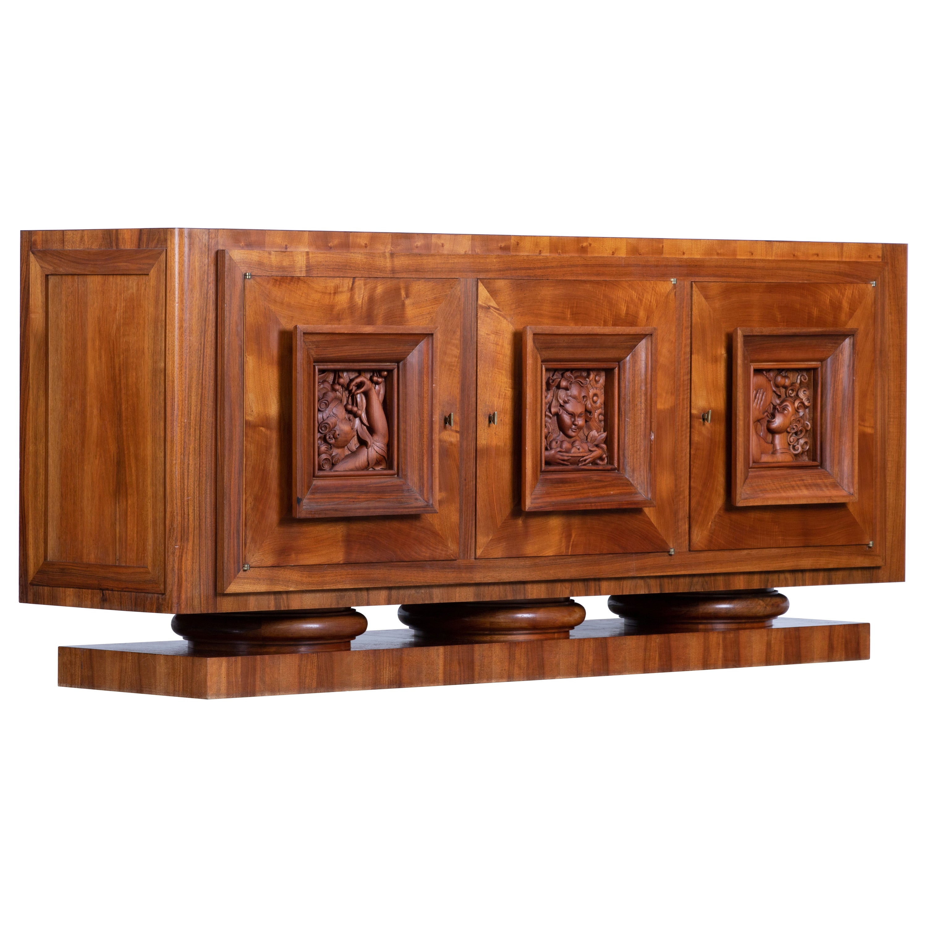 Credenza, solid oak, France, 1940s.
Large Art Deco Brutalist sideboard. This heavy Brutalist credenza seems to float on its elegant base. The credenza consists of three large storage facilities and covered with hand sculptured door panels. The