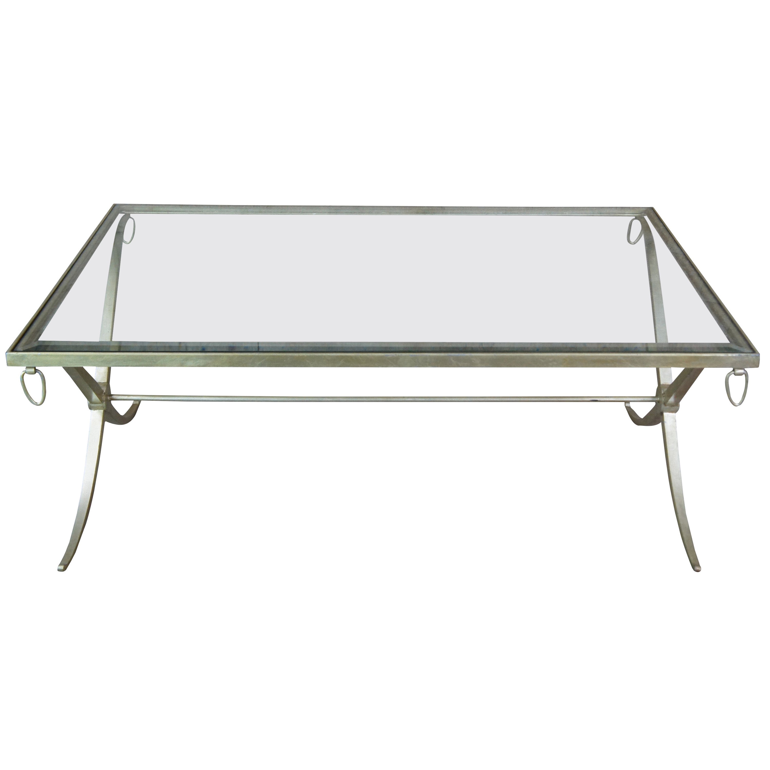 Barbara Barry for Baker Furniture iron and glass coffee table featuring rectangular form supported by an iron frame with hanging rings at each corner of the apron, x-form legs, and a round stretcher support.  Champagne color finish.
 