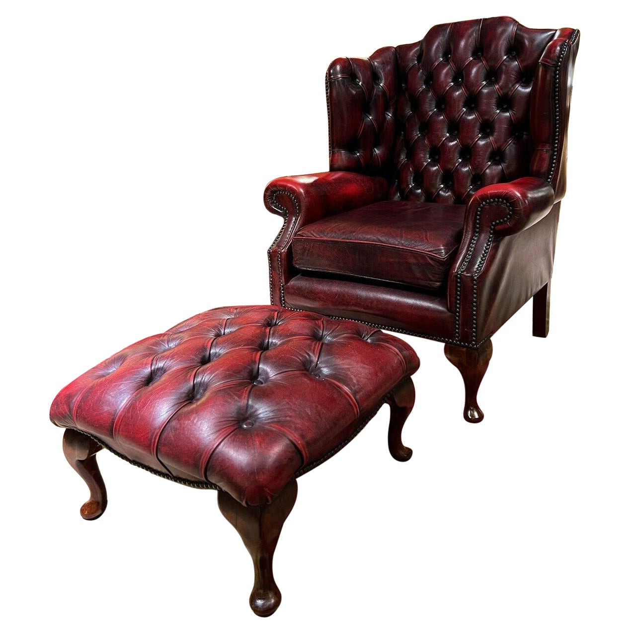 Vintage original Chesterfield Oxblood Leather Wingback  Armchair and Footstool For Sale