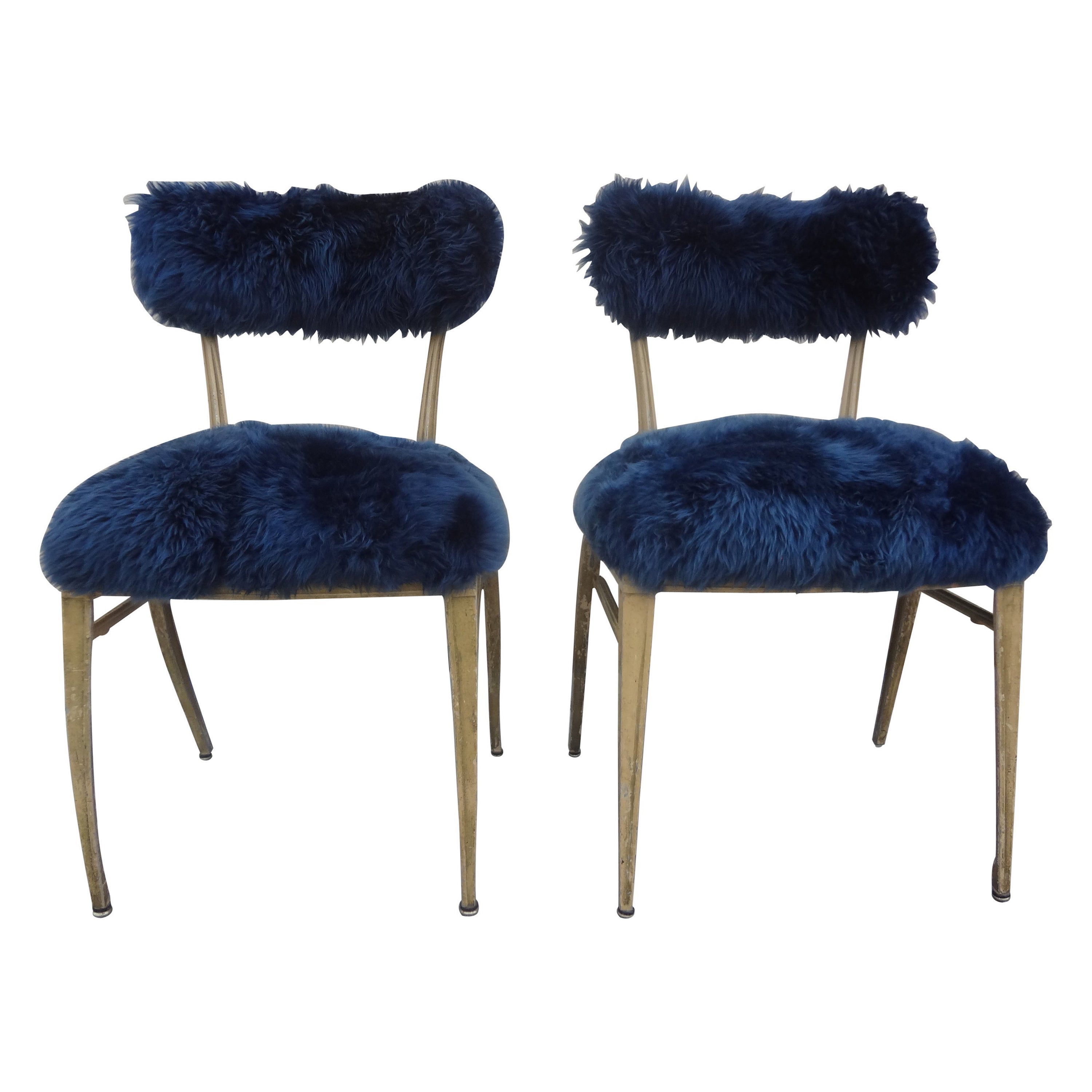 Pair of French Modern Jean Prouvé style metal chairs upholstered in blue sheepskin. These French midcentury chairs or side chairs have a great distressed painted finish and are the perfect addition to your Modernist interior!.