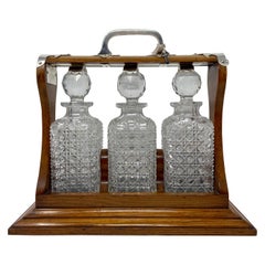 Antique English Silver Mounted Oak Cut Crystal Three Bottle Tantalus, circa 1880
