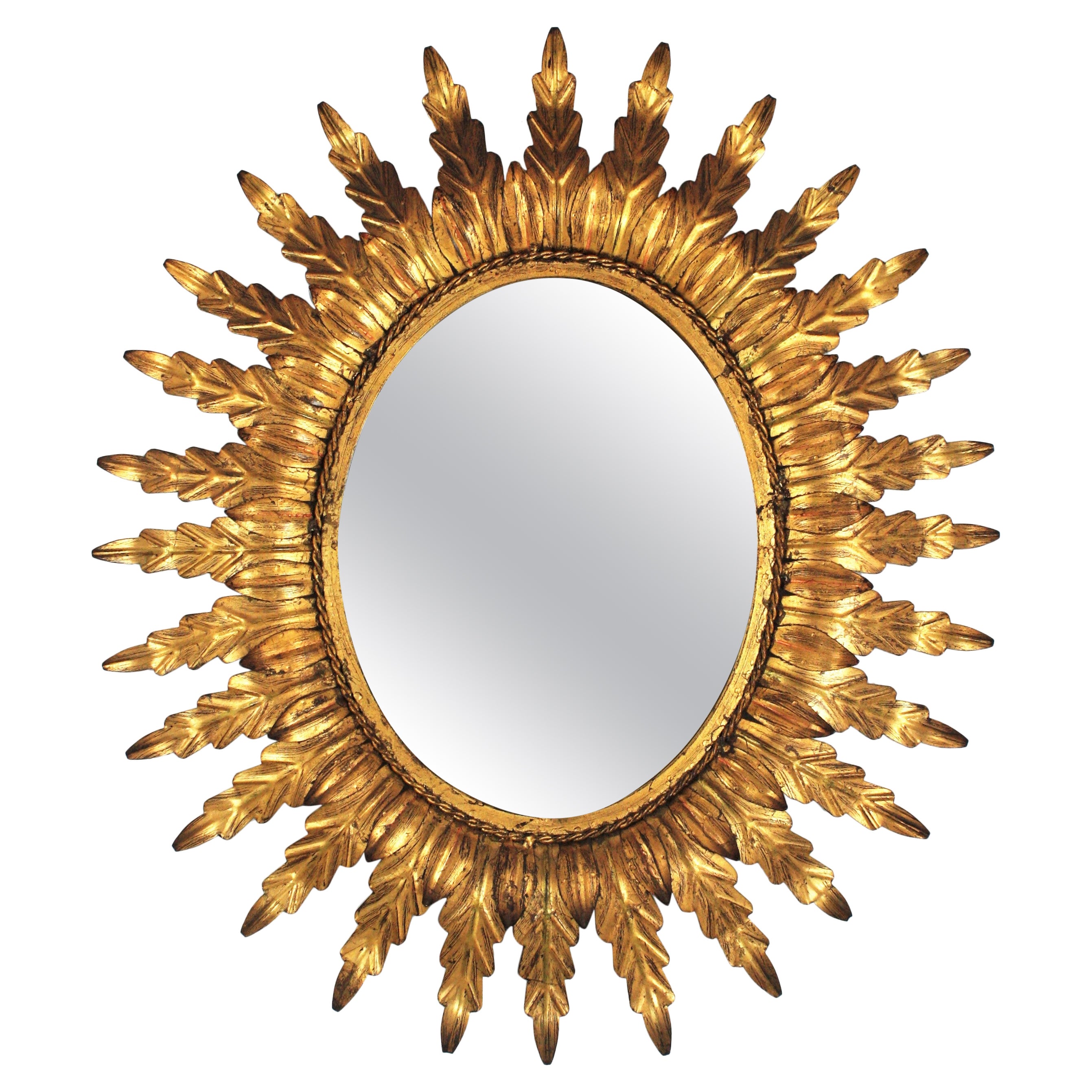 Miroir ovale doré Sunburst avec cadre feuillagé en vente