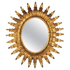 Gilt Sunburst Oval Mirror with Leafed Frame