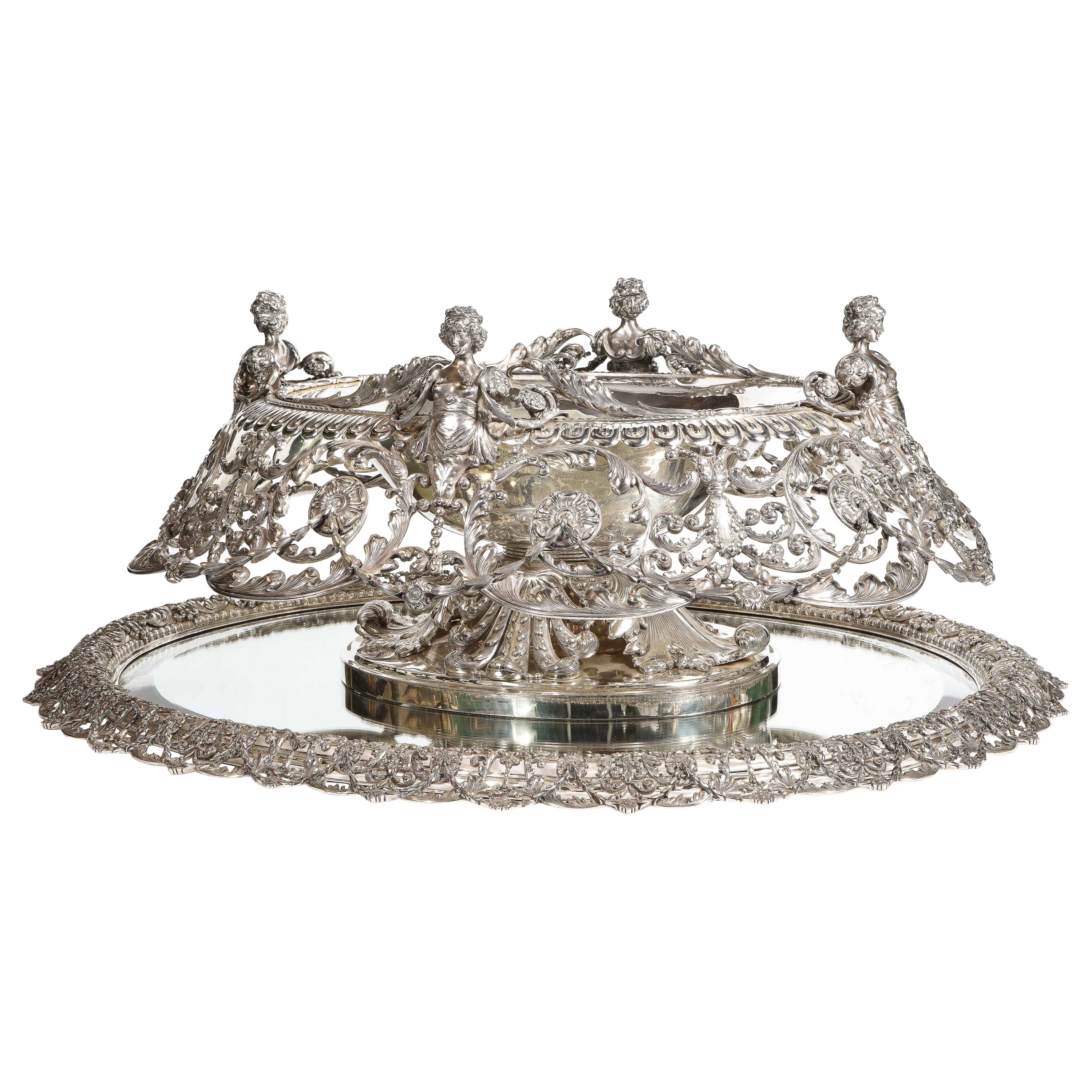 Tiffany & Company and George Paulding Farnham, A rare, lavish and monumental sterling silver centerpiece with original mirrored-glass sterling silver plateau, circa 1900.

Museum quality. 

In the George III style, designed by Paulding Farnham for