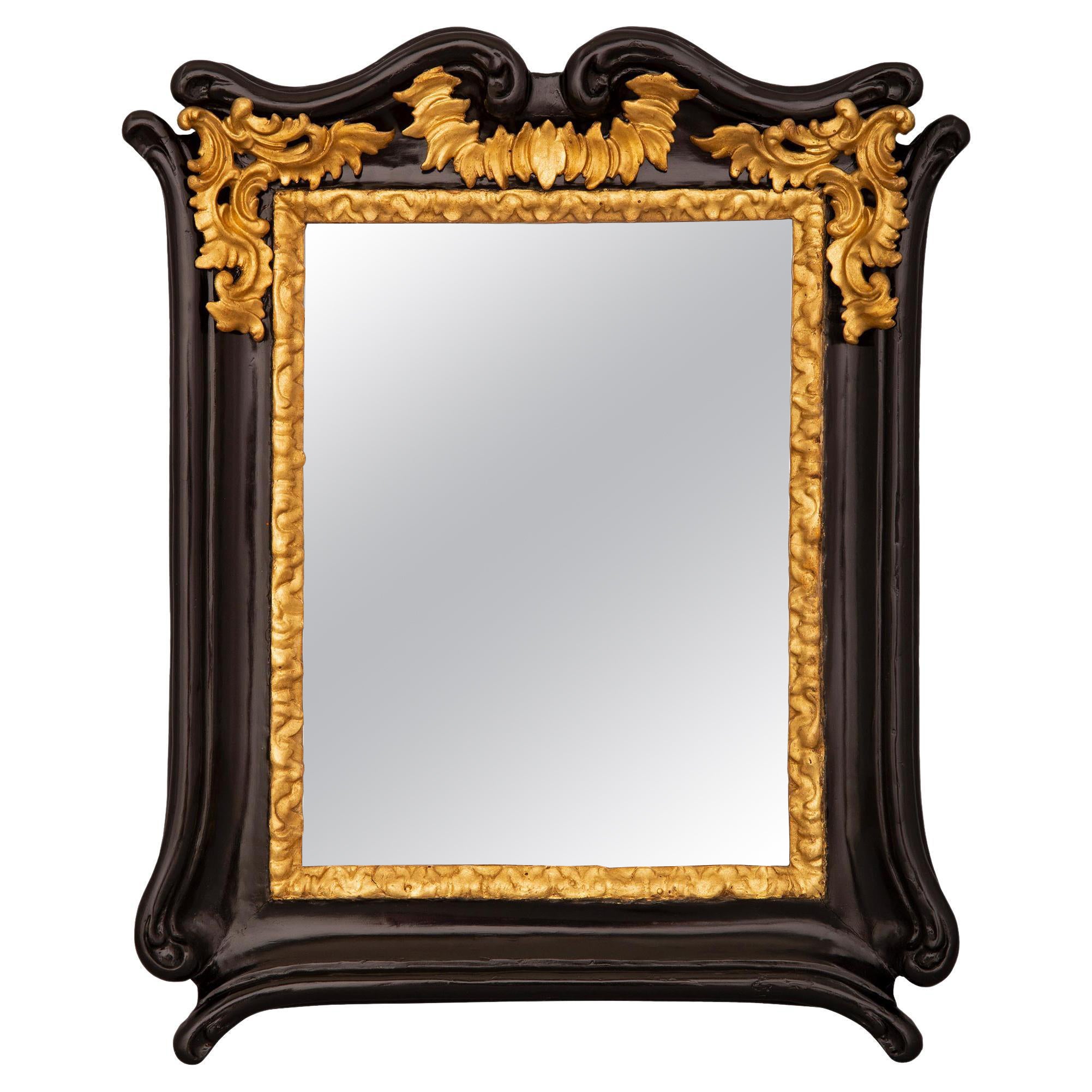 Italian 18th Century Baroque St. Ebonized Fruitwood and Giltwood Mirror For Sale