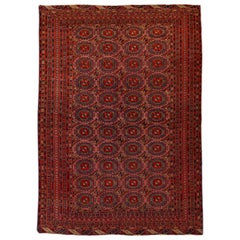 Tapis vintage turkmène géométrique en laine persane fait à la main avec couleur terre cuite