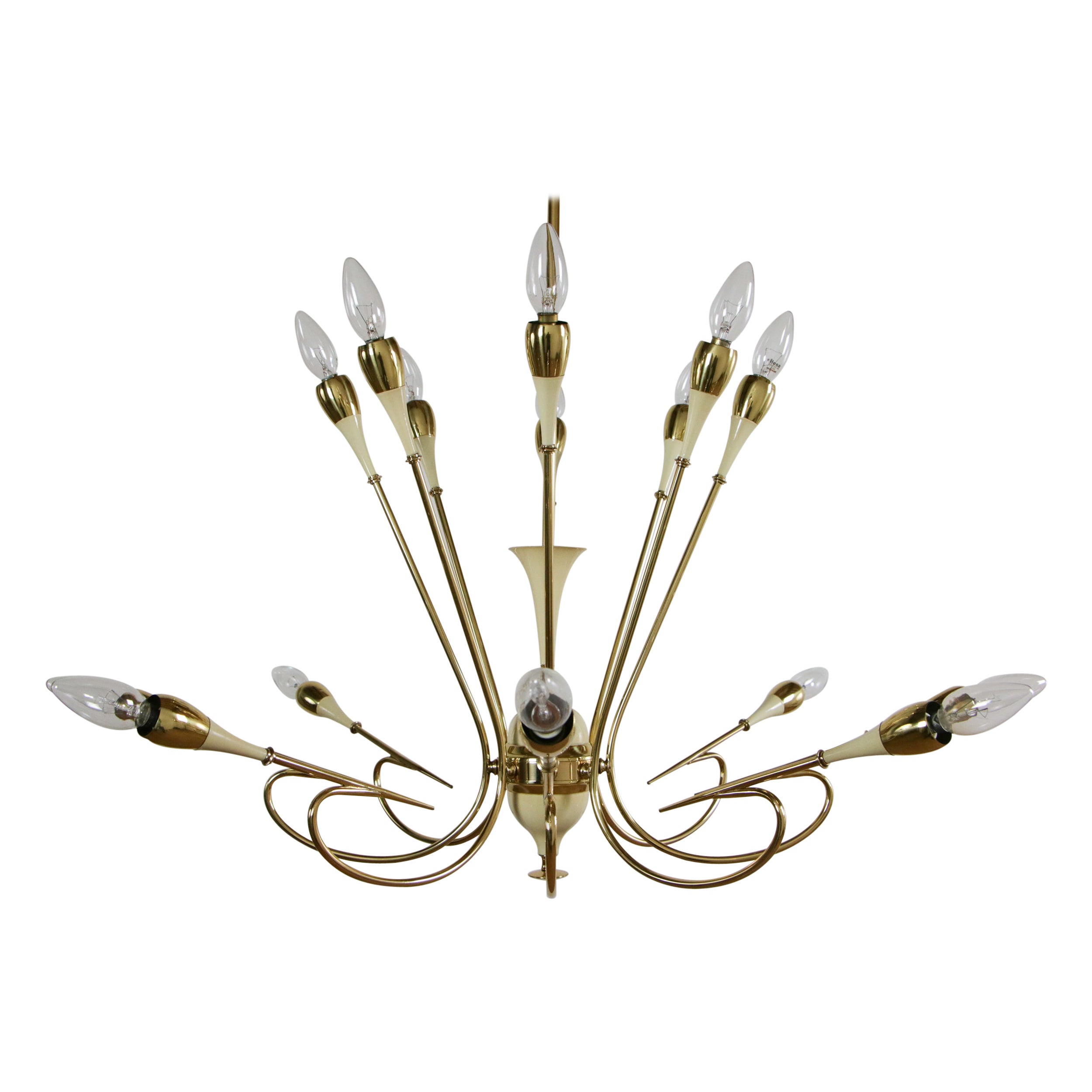 It is a stunning and rare Italian mid-century chandelier by Oscar Torlasco for Lumi Milano. The chandelier is made of brass and ivory lacquered aluminum with 16 E14 lights. It has the exceptional executive quality and the brass parts are a design