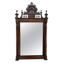 Early 20th French Ebonized Mirror with Turned Columns and High Carved Details