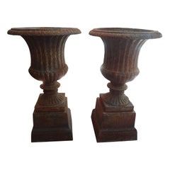 Pair of 19th Century French Neoclassical Style Iron Urns on Plinths