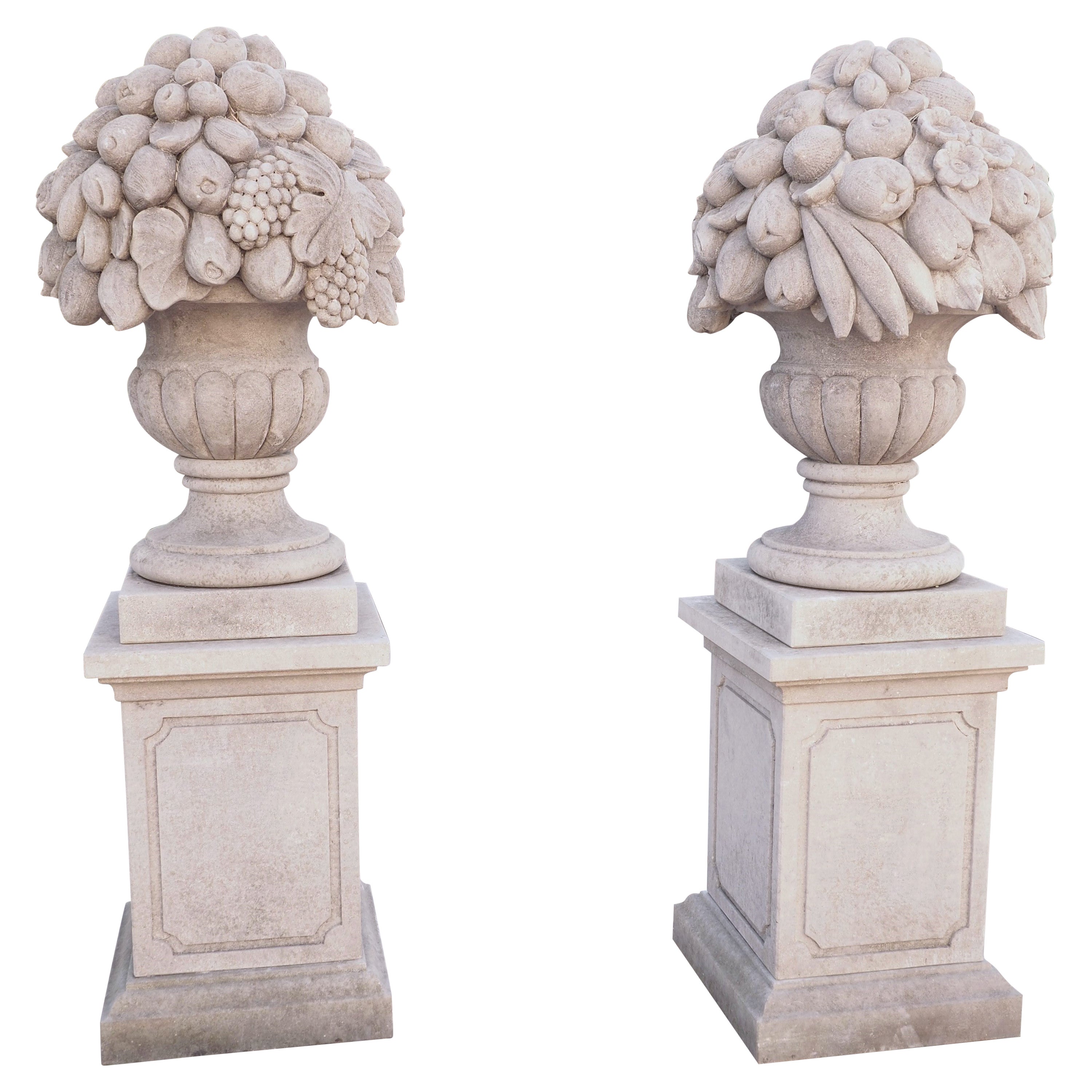 Pair of Italian Limestone Urns with Fruit and Floral Bouquets on Pedestals For Sale