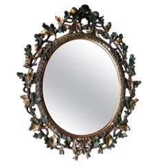Miroir mural ancien en bois laqué doré