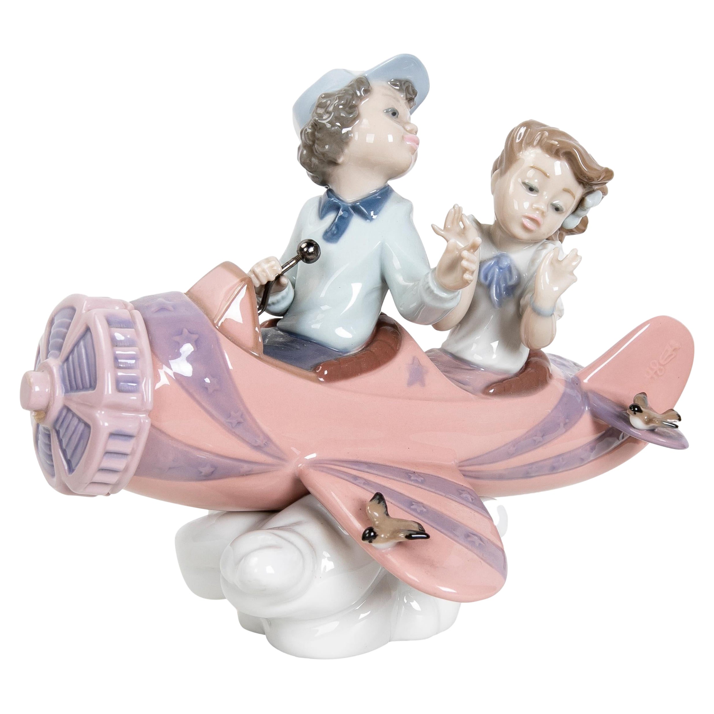 1989 Figurine en porcelaine représentant des Child & Child dans un avion, signée par la maison LLadró