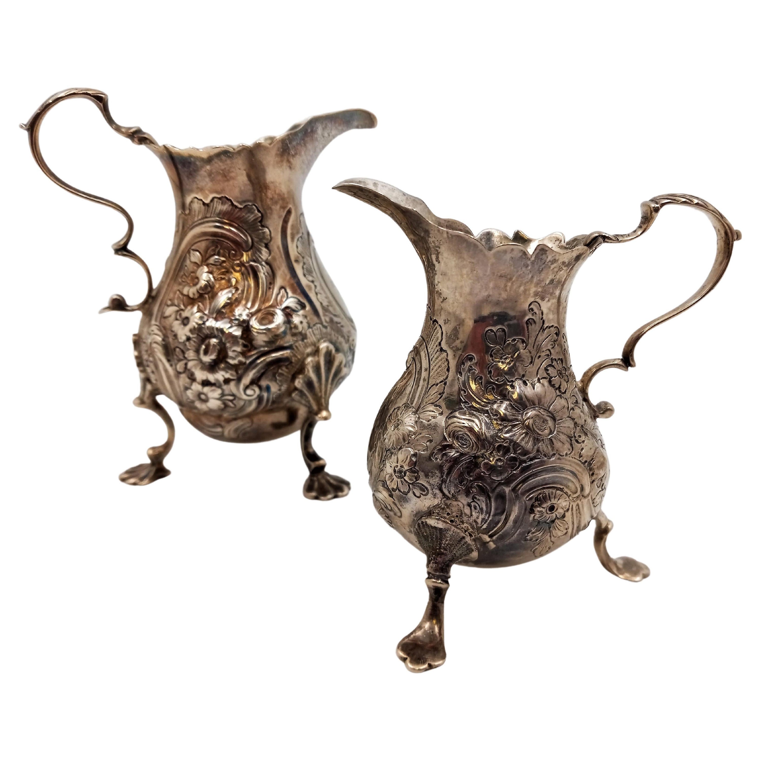 Pair of English Silver Georgian Cream Pitchers on Shell Legs with Floral Pattern For Sale