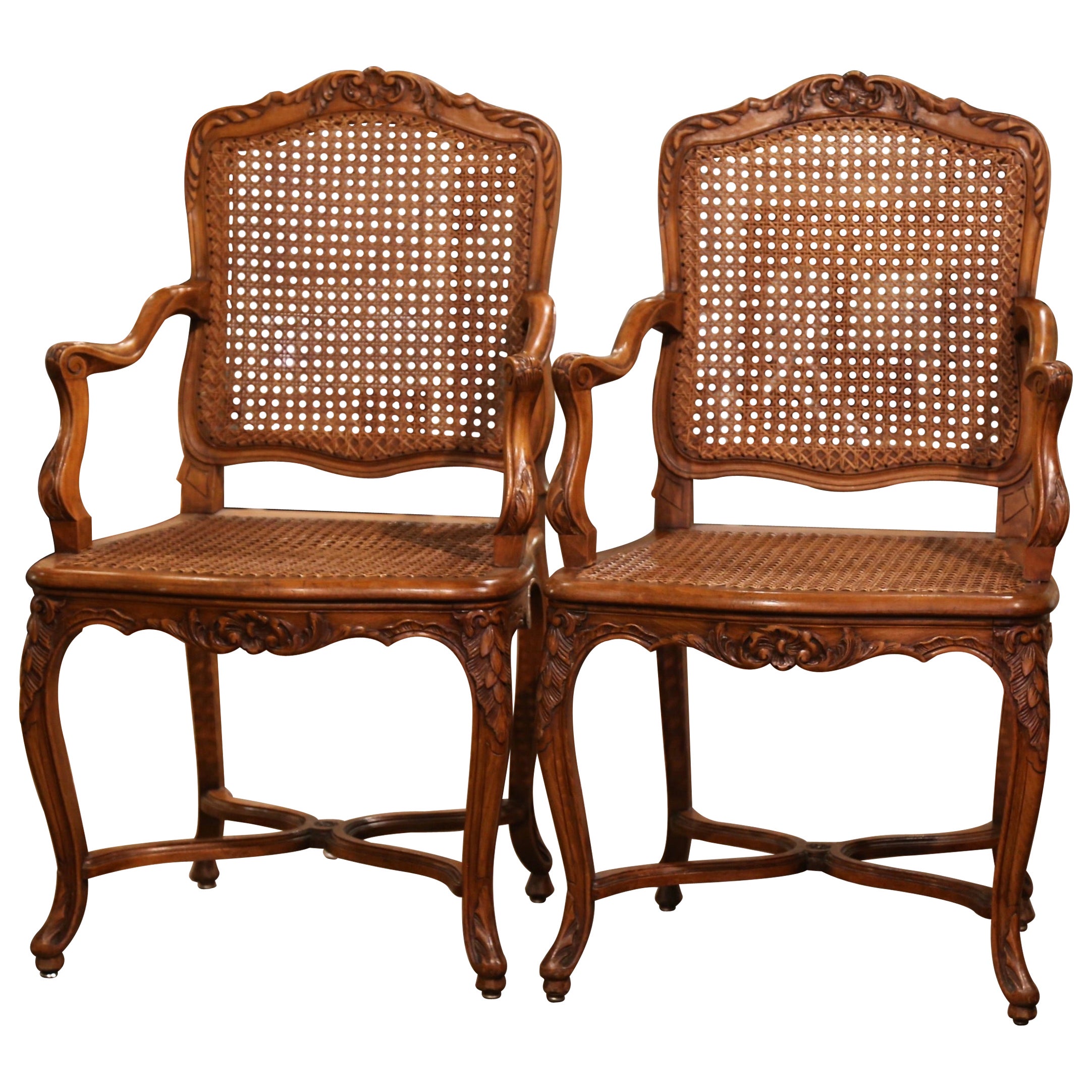Pair of Early 20th Century French Louis XV Carved Walnut and Cane Armchairs