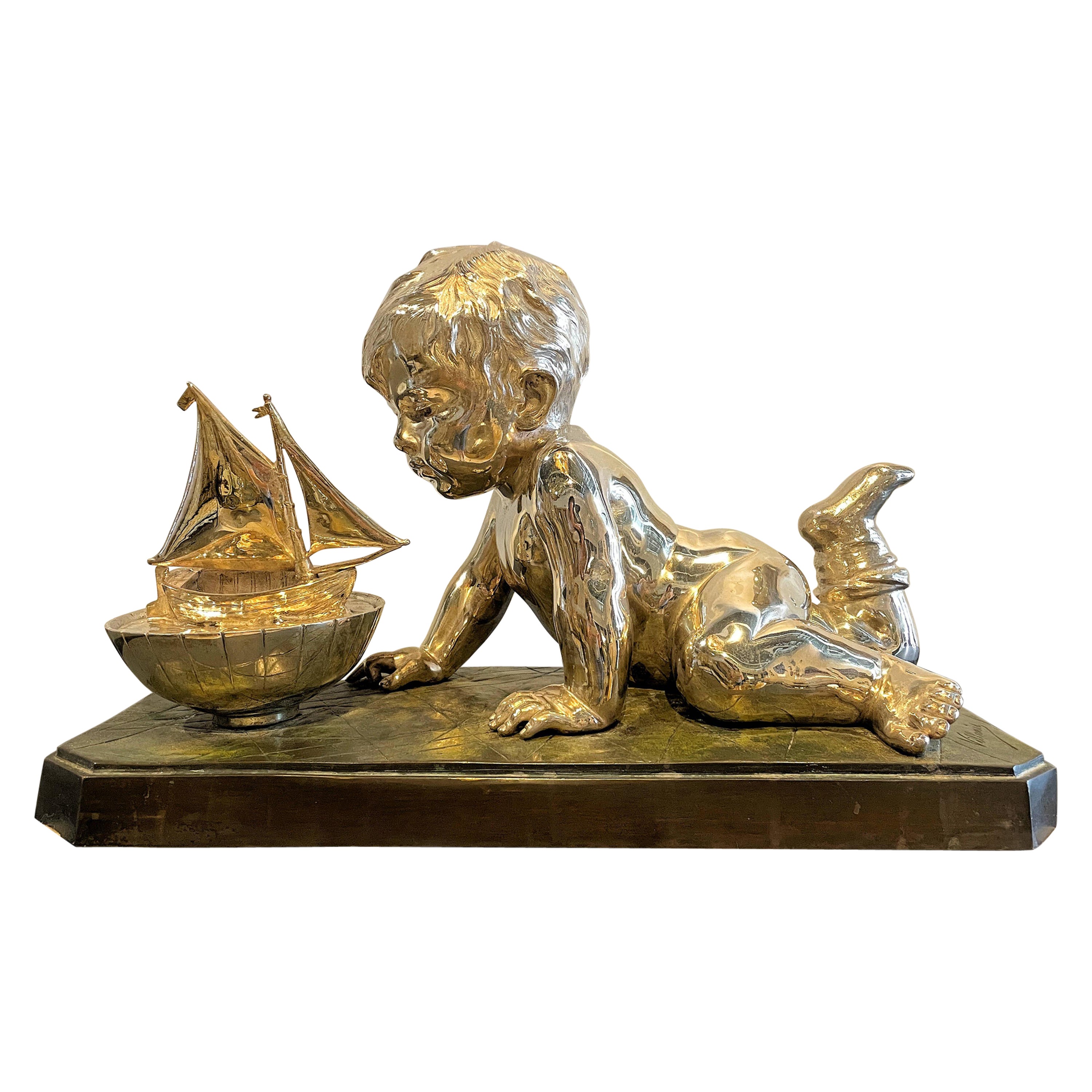 Early 20th Century Silvered Bronze Enfant Jouant Avec Un Bateau For Sale