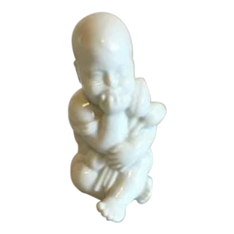 Royal Copenhagen Blanc de Chine Figurine of Baby with Flowers For Sale