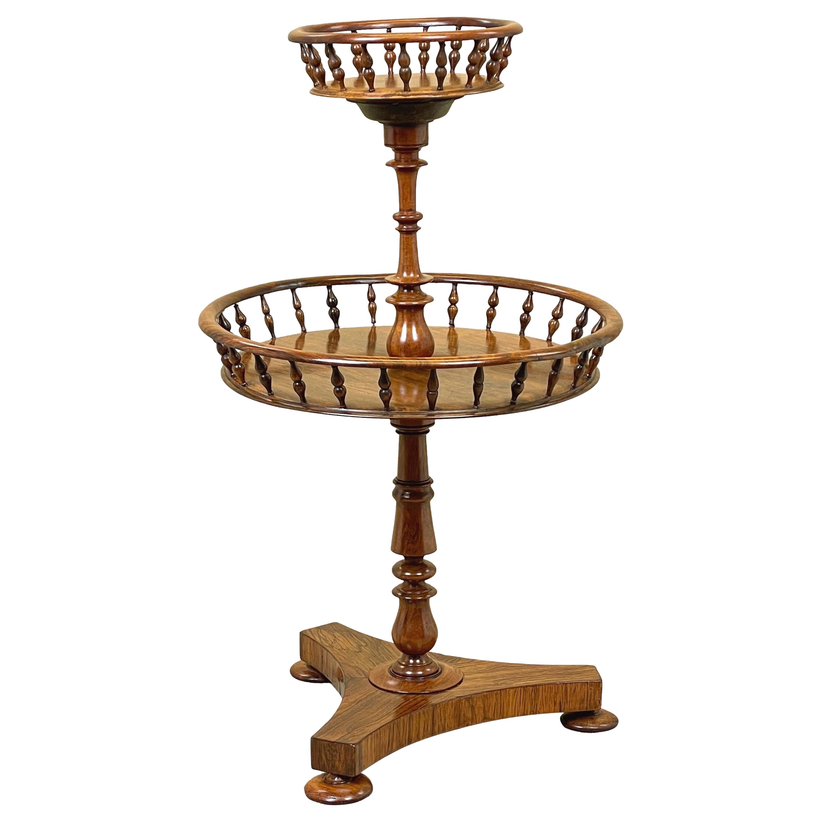 A very good quality Late Regency Period rosewood circular occasional table of unusual design, possibly originally designed for storage of wool, having two well figured circular tiers with elegant spindle turned galleries united by turned central